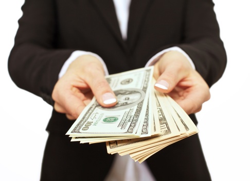 Cutout of business person in suit jacket fanning out a lot of paper money.